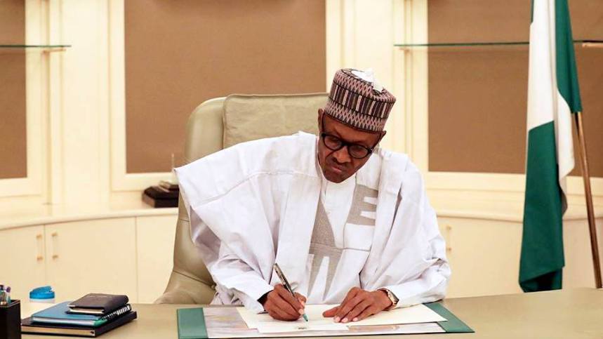 President Muhammadu Buhari of Nigeria signing an offficial document
